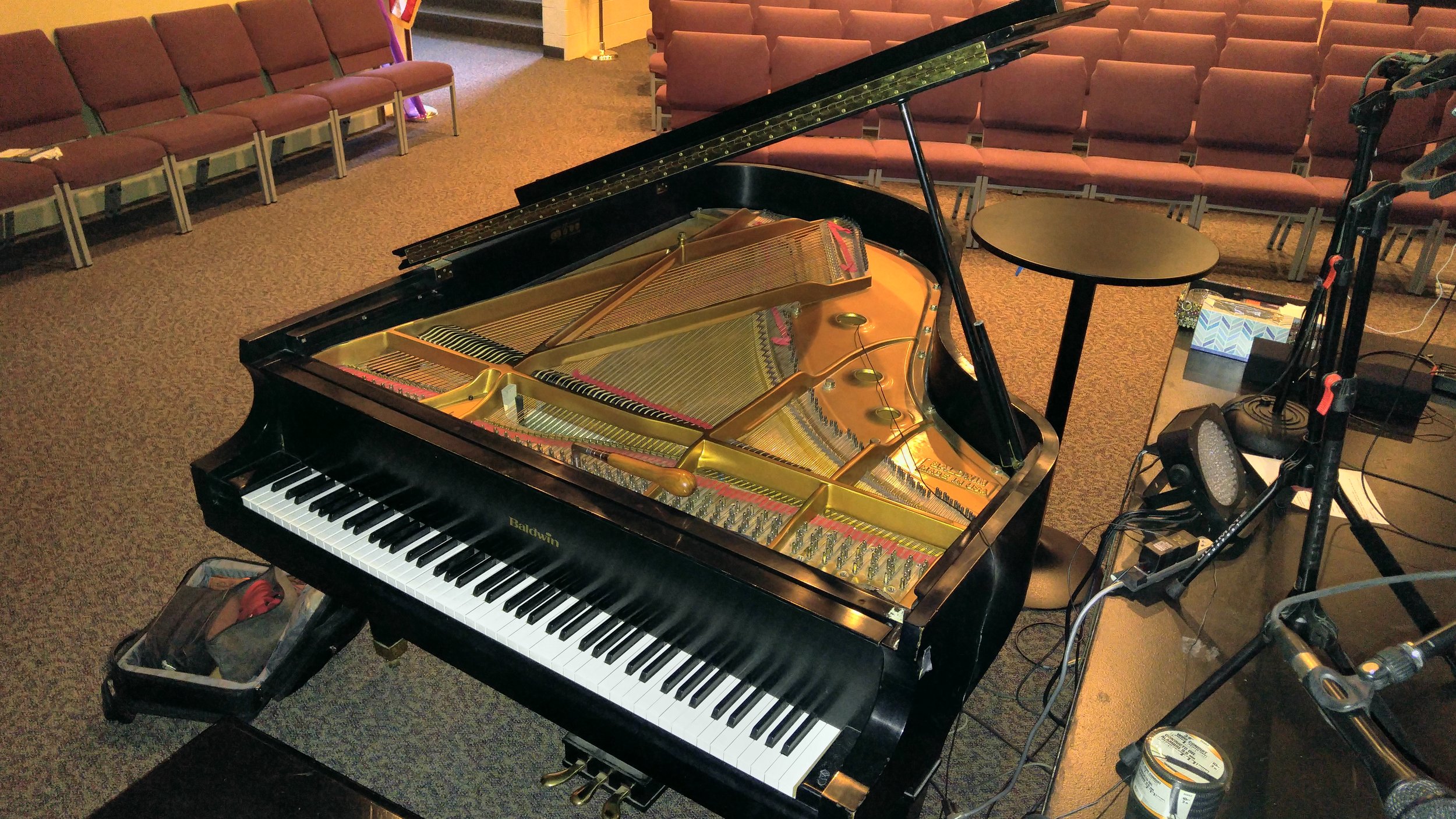 A grand piano prepared in a performance room